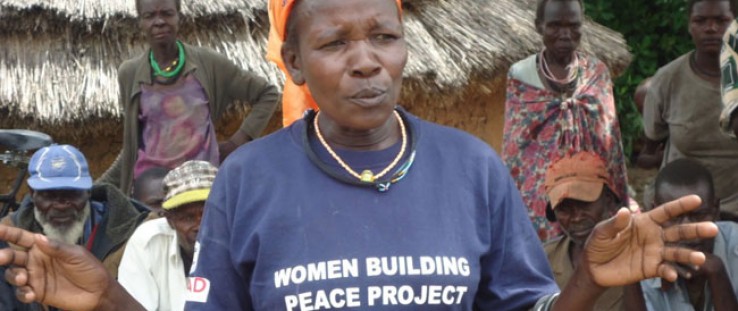 A peace committee member speaks to a group about early marriage and education for girls in Napak district.