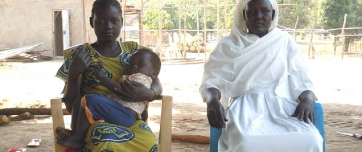 Suzanna Ile and her son Modi at the USAID-supported Lokiliri Primary Healthcare Centre, with the community midwife who helped en