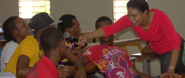 Volunteer Donna Gabbadon interacts with youth at a leadership skills seminar in 2014.