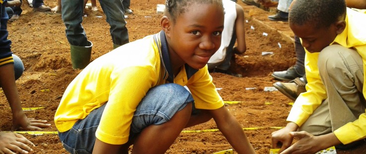 Students at Ndlelenhle Primary School in Vosloorus, Gauteng, plant Reel Gardening seeds.