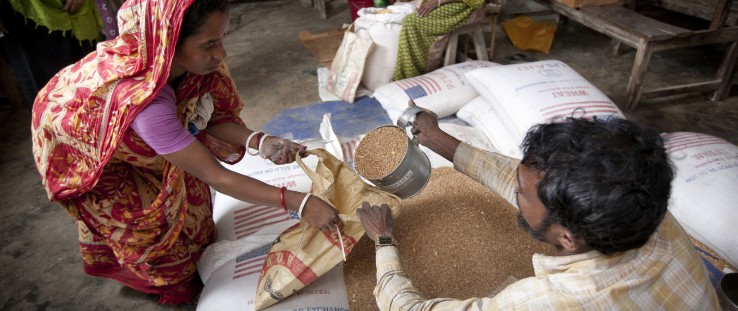 A woman receives grains in Bangladesh