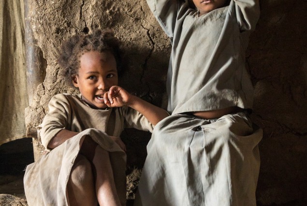 Two of the children of USAID beneficiaries Yubo Kereyu and Barude Keweti. Discussions about gender and social norms within the village economic and social association have encouraged their parents to share household chores and childcare. When they do, everyone benefits.