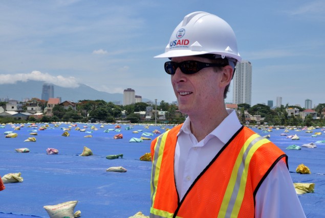 USAID Mission Director Joakim Parker assesses progress at the Environmental Remediation of Dioxin Contamination Project at Danan