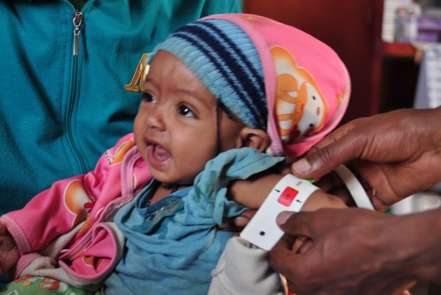 Natsaannat, a health extension worker in Wara Village, Ethiopia, counsels Aynamam on how to treat malnutrition in her child, Bitu.