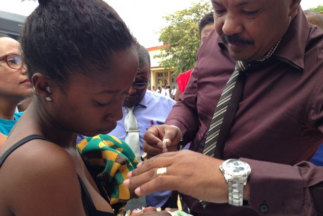 visiting official administers polio to infant