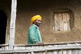 Getachew Tadesse on the porch of his new house. Like many USAID beneficiaries, Misaye Akele (not pictured) and her husband Getachew Tadesse (pictured) feel that the greatest changes to their lives and livelihood have come about as a result of the USAID's training on gender. By stepping out of traditional gender roles and working together, they are not only happier, but also better off. This year they put much of their extra income into building the family a new house.