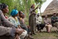 A culture of saving. A member of Nigat Chora (Sunrise) Village Economic and Social Association (VESA) stands up to speak during a meeting. Comprised of groups  of neighbors and peers, VESAs are the foundation of all GRAD-supported activities. VESAs also provide savings and credit facilities to members. When Nigat Chora was established five years ago, its 23 member households were some of the poorest in the community. Today a 'culture of saving' has helped transform members' lives.