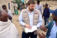 USAID Office of Foreign Disaster Assistance Director Jeremy Konydnyk discusses how Ethiopia's drought is affecting residents in the Enderta Woreda of Tigray Region. A Catholic Relief Services representative (right) is explaining how the current well rehabilitation will help alleviate the suffering by community members.