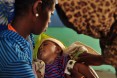 Natsaannat, a health extension worker in Wara Village, Ethiopia, examines Tamrat because his mother, Mebrat, is concerned he may have TB. Diagnosis: Cold.