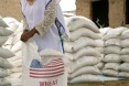 In Aje, families gather to take home rations of wheat and split yellow peas under the program, implemented by a number of national and international partners working under CRS' management.