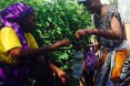 USAID staff member is using a tippy-tap to wash her hands