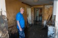 Maglaj man stands in his living room, preparing to clear mud left behind after devastating floods in Bosnia in May 2014.