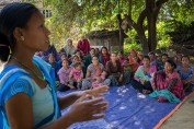 A health worker talks to a group of women.