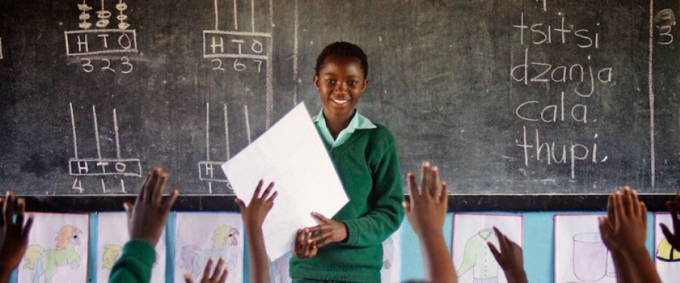 A pupil at Kasenje Primary School in Kafue considers a sea of raised hands, each looking to answer her questions about the story