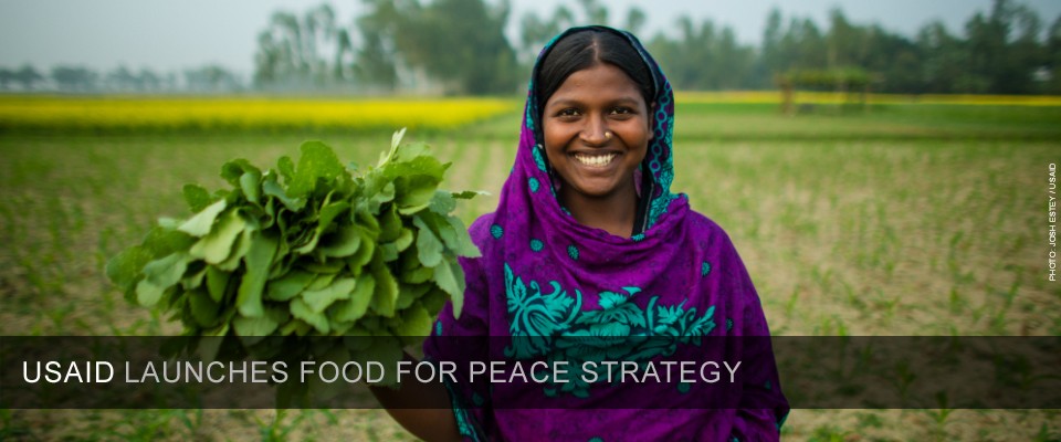 A woman holds part of her crop in Bangladesh