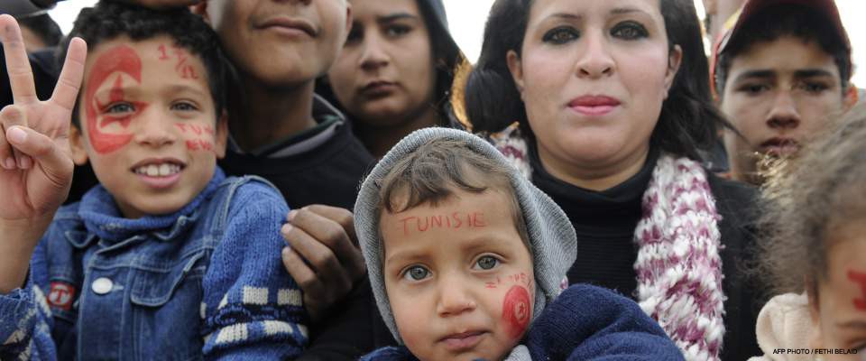 Tunisian children attend a rally at Sidi Bouzid's Mohamed Bouazizi square, named after the fruitseller whose self-immolation spa