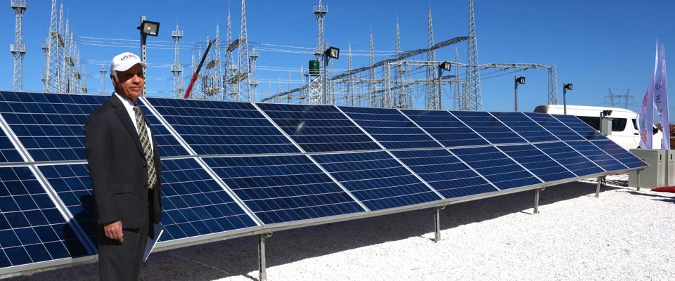 USAID/Zambia Mission Director Dr. Michael Yates views solar panels before the start of the Scaling Solar launch event