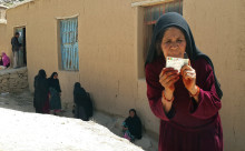 A woman poses for a photo after casting her vote in Daikundi province, June 14, 2014.