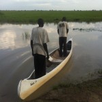 Two South Sudanese fishermen set out in a USAID-provided canoe to bring fish and much-needed goods back to their communities.