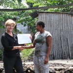 USAID Mission Director Susan Sawhill Riley presents a training certificate to Radiata Ibrahim