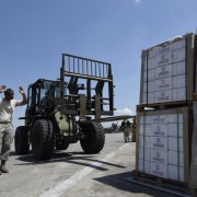 Tech. Sgt. Ronald Rowe, 621st Contingency Response Wing, facilitates transport of USAID food and provisions.