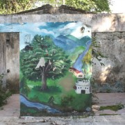 A mural painted by the community of Mampuján represents three moments: life before the conflict, after the displacement, and exp