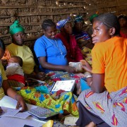 A member of a village savings and loan association in Kalulu, Kabare, signs for a loan of 20,000 Congolese francs (around $22). 