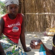 Community health worker Rosalina Casimiro meets with children in Nampula province, Mozambique, to demonstrate how to purify wate