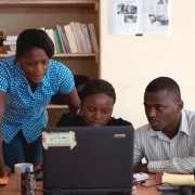 ENDK journalist Witza Petit Antoine is flanked by Internews researchers Louisena Louis, left, and Franck Lafont as they sort SMS