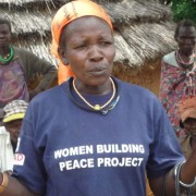 A peace committee member speaks to a group about early marriage and education for girls in Napak district.