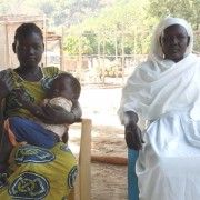 Suzanna Ile and her son Modi at the USAID-supported Lokiliri Primary Healthcare Centre, with the community midwife who helped en