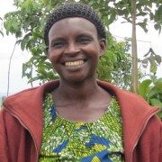 Annociate Musabwamana, center, stands with two farmers she trained under Sell More For More.