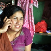 A small entrepreneur uses her mobile banking services to pay for her supplies. 