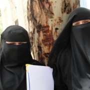 Two community educators prepare for a training session on the safe age of marriage. Twenty men and 20 women were selected from a