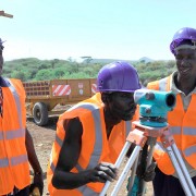 Workers survey a biomass site in Kenya.