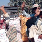 Punjabi farmers return home after receiving 50-kilogram sacks of wheat seed, fertilizer, and vegetable seed as part of USAID's $