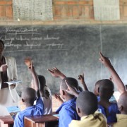 Teacher Beatha Nikuze interacts with students in her third grade classroom at Kanyinya Primary School.