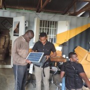 Steve Wasira, left, visits Off Grid Electric, a partner of the Power Africa sub-initiative, Beyond the Grid.