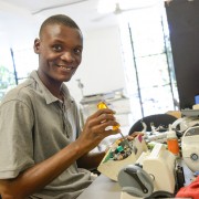 Andy Saint-Louis repairing medical equipment.