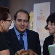 USAID Mission Director converses with a training participant.