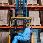 A worker lifts a pallet onto the vertical racking system in a Pharmaceutical Fund and Supply Agency warehouse in Kality.