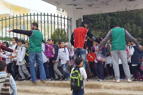 The dad-led School Brigade helps children safely cross the street to school