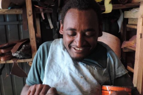 Melesse Yohannes uses his “Rough Rider” wheelchair to go out and buy supplies for his shoe-making and repair shop.