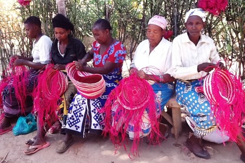 Women weavers in Kitui, Kenya constructing baskets destined for Walmart.