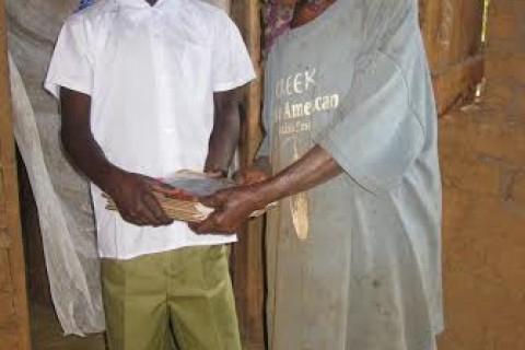 A grandmother readies her grandson for school